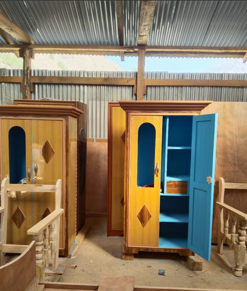 Vibrant blue and yellow restroom cabins in a rural Himalayan area.