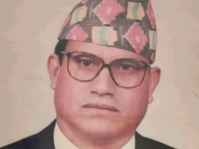 a man with glasses and dhaka topi